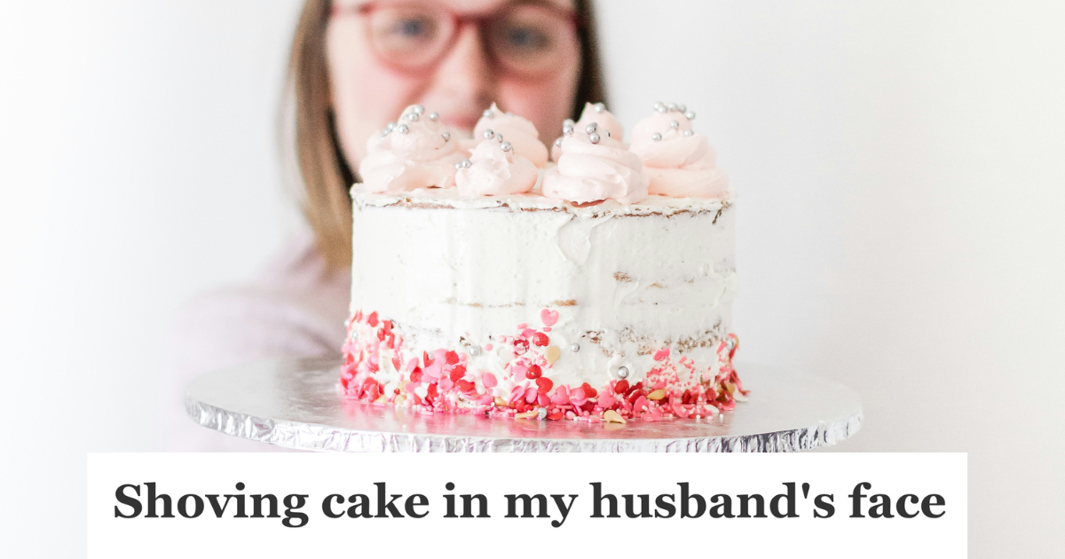 woman holding up a pink cake