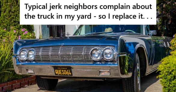 Lincoln vintage car near a fence