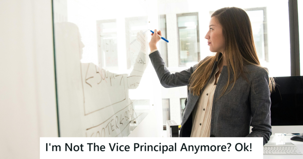 Woman in suit writing on a white board