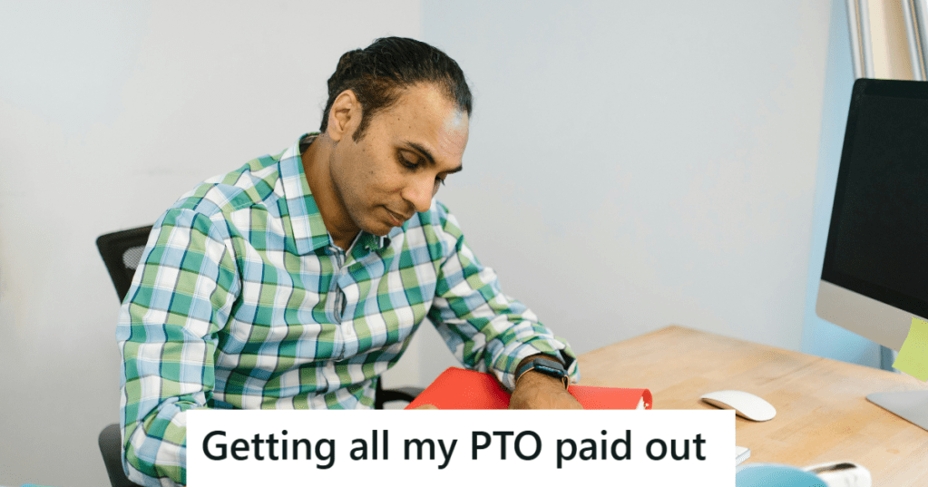 Man in checkered shirt working in office