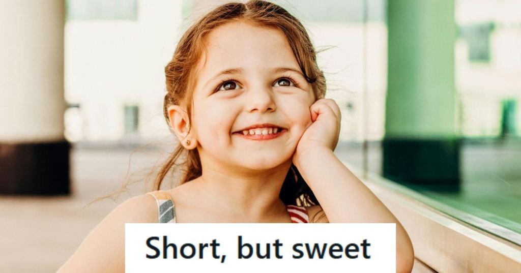 Little girl posing for the camera with a giant smile on her face