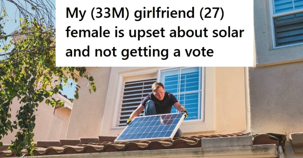 Man installing solar panel on roof