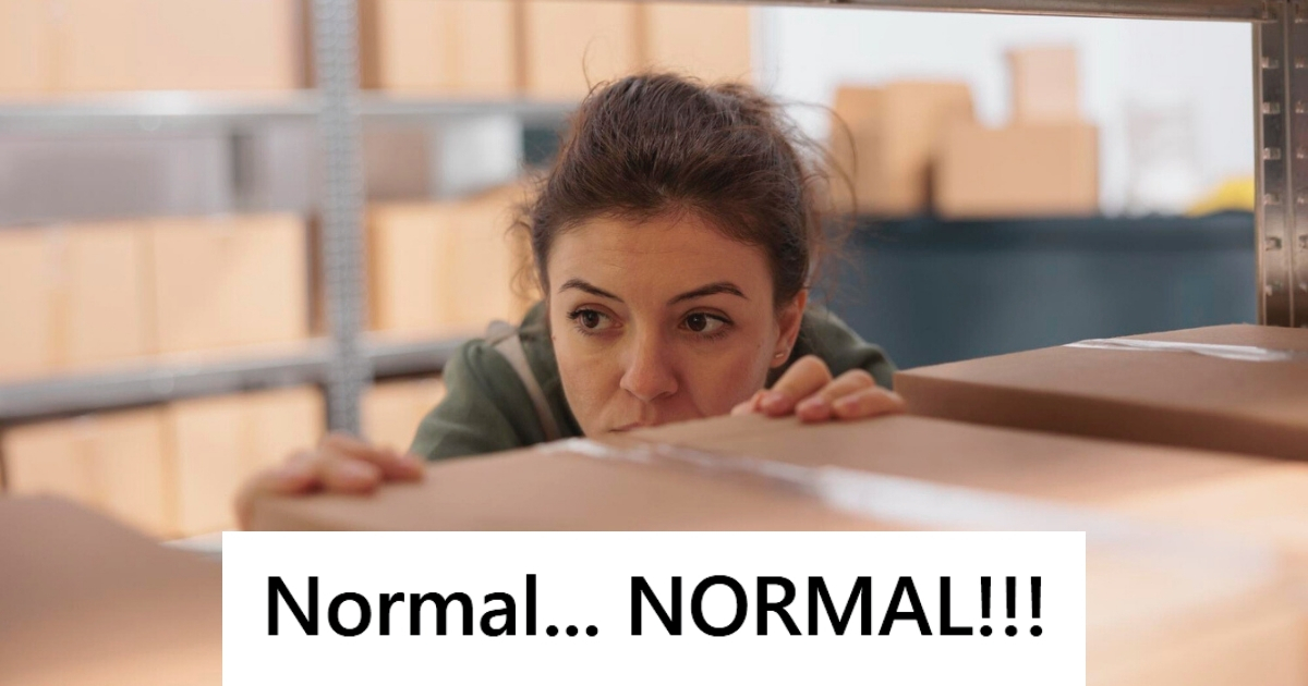 Woman looking at boxes at warehouse