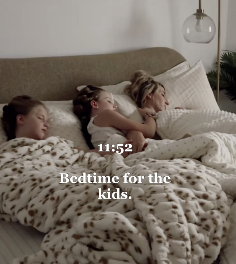 mom in bed with two daughters