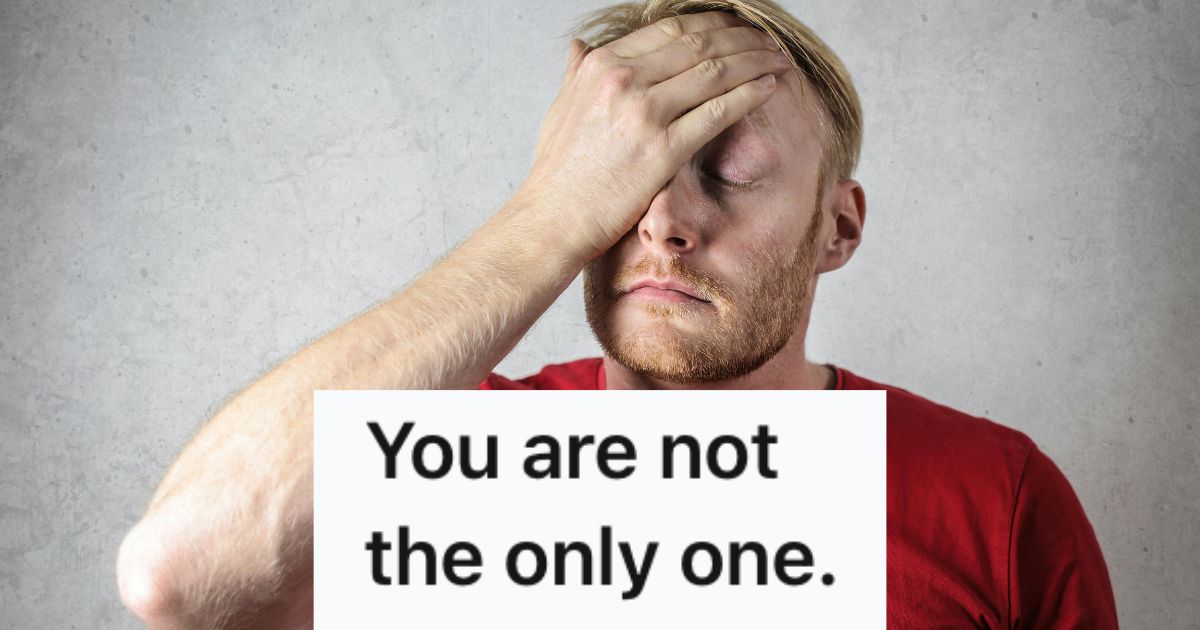 A man in a red shirt doing a face palm