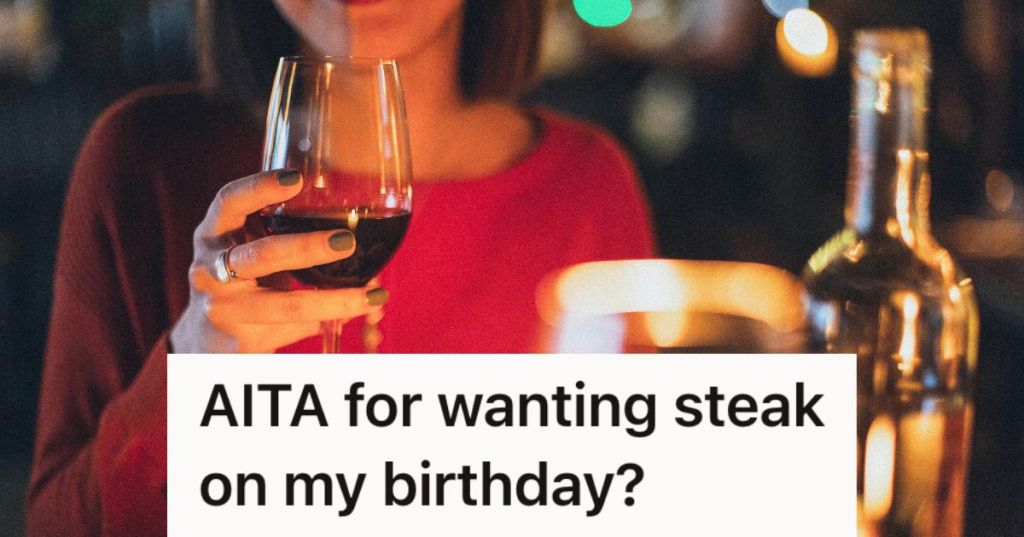 Woman holding a glass of wine at dinner