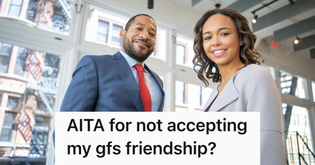 A man and woman posing in business attire