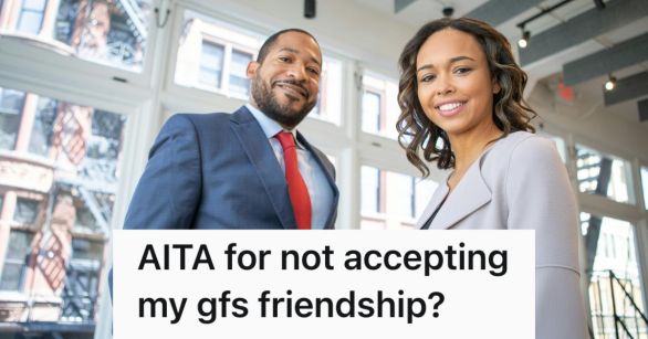 A man and woman posing in business attire