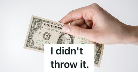 Handing holding a US bill