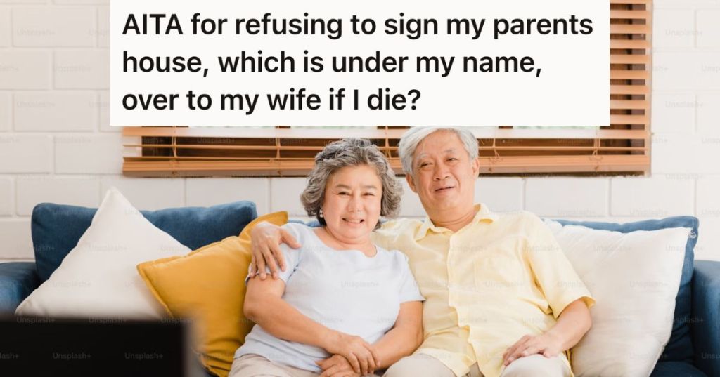 Older couple sitting on a couch smiling