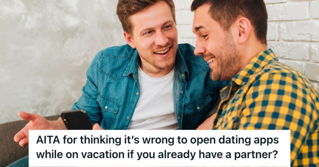 Two men looking at a phone and smiling