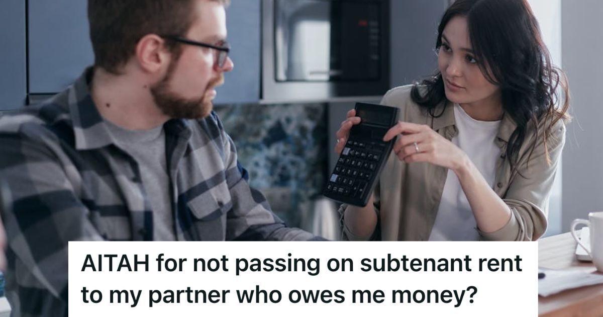 Woman showing a man a calculator while sitting at a table at home