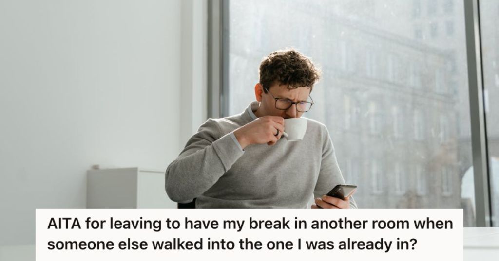 Man drinking his coffee and looking at his phone