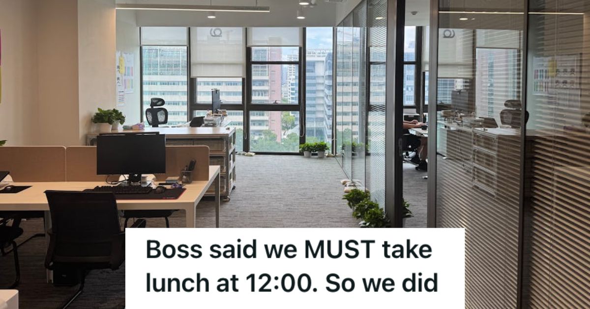 An empty office floor with only tables, chairs, and computers