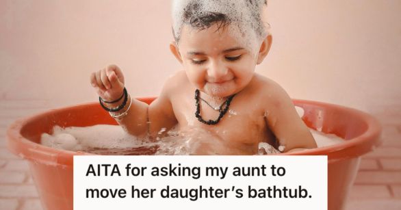 Baby taking a bath in small tub with bubbles
