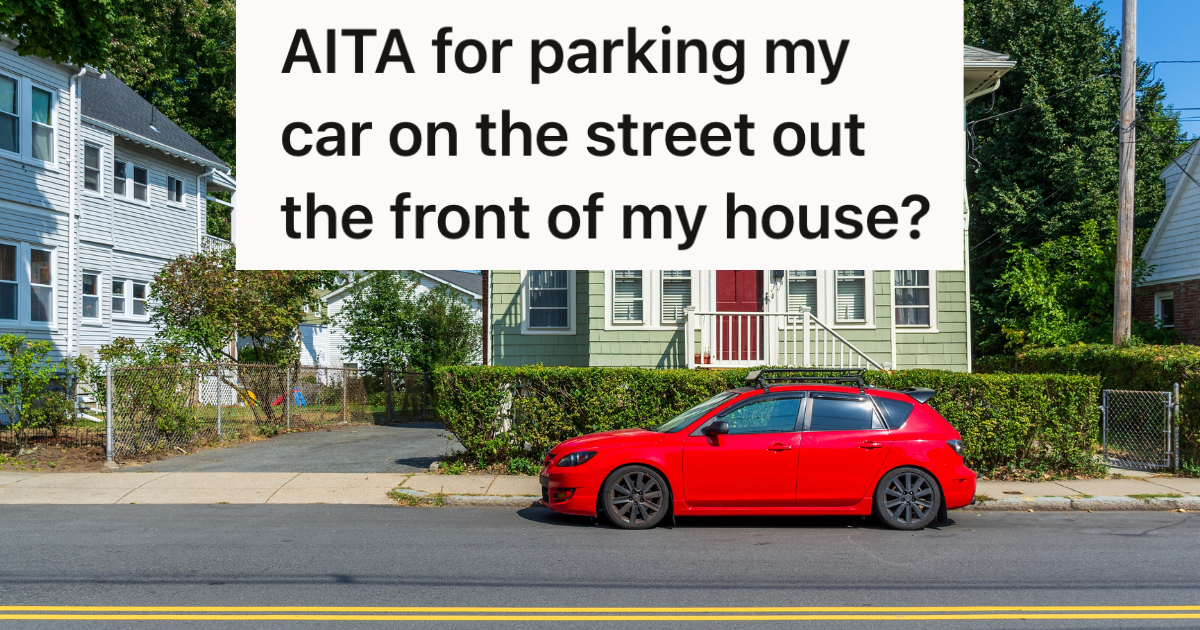 red car parked on street in front of house