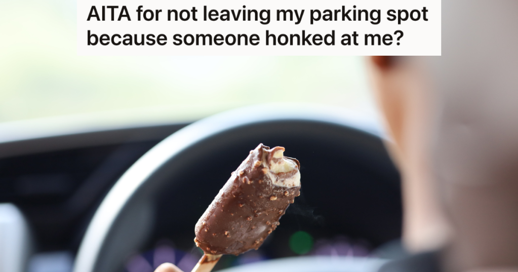 man eating ice-cream bar in car