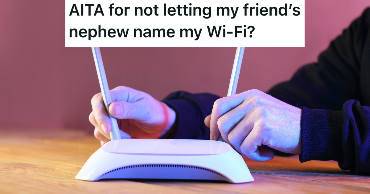 man adjusting internet router antennas