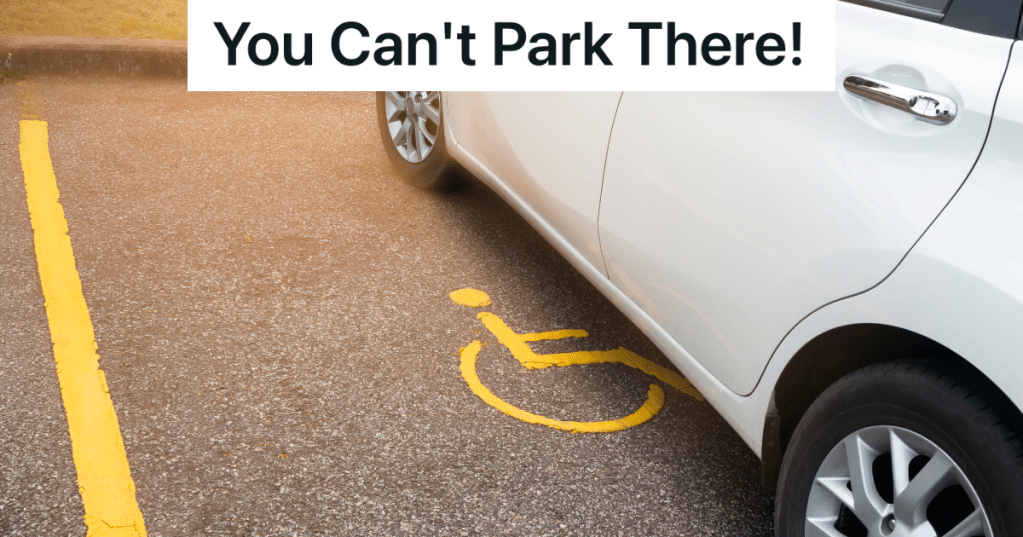 white car parked in handicapped parking spot