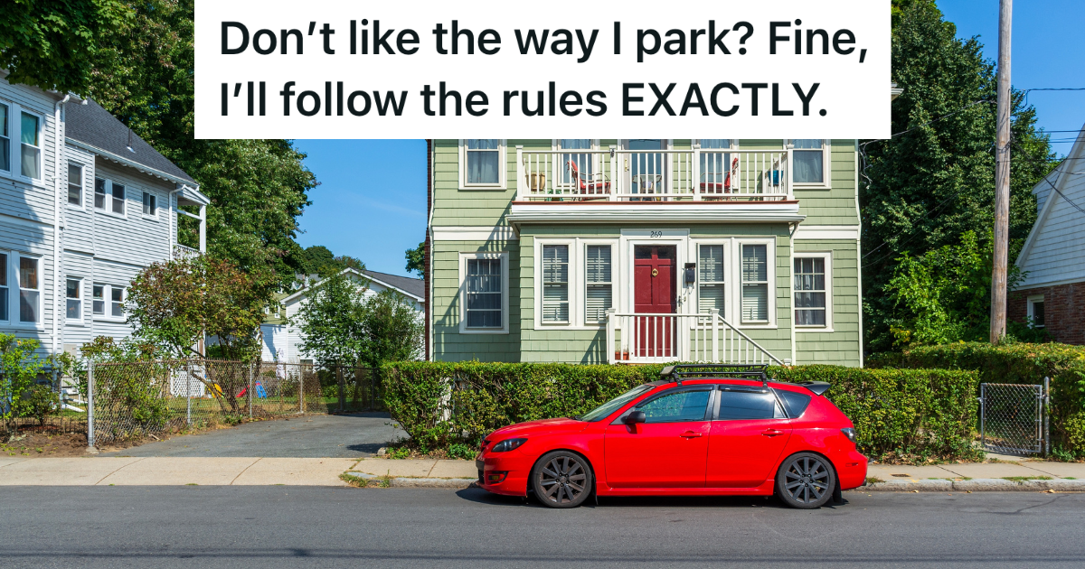 red car parked on street in front of house