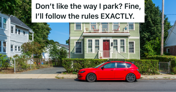 red car parked on street in front of house