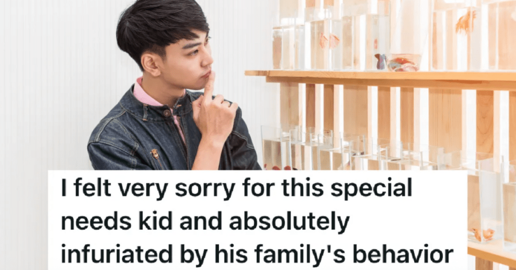 teen boy staring at fish in tanks