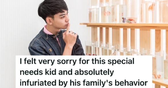 teen boy staring at fish in tanks