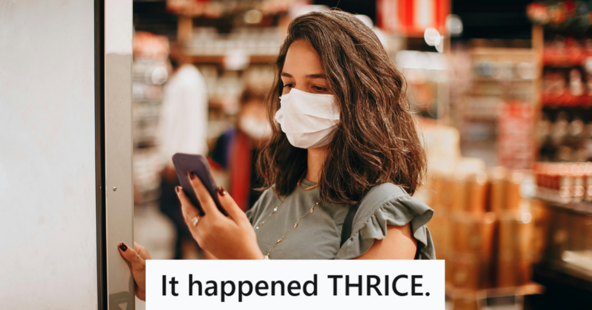 woman looking at phone while shopping