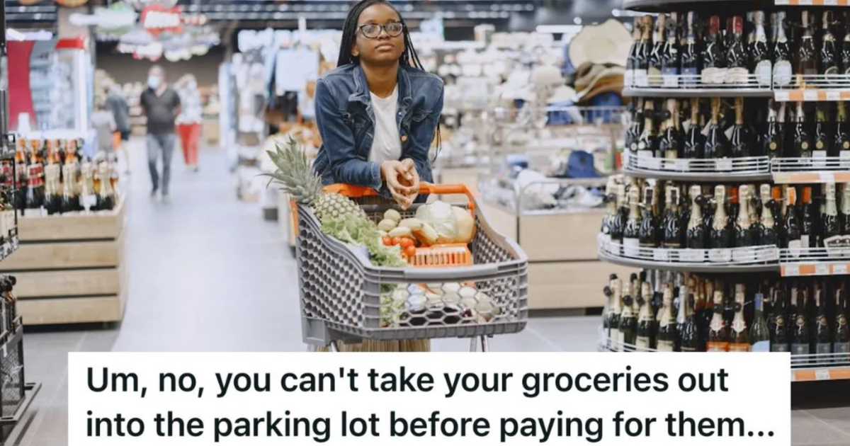Woman in grocery store pushing a cart full of items