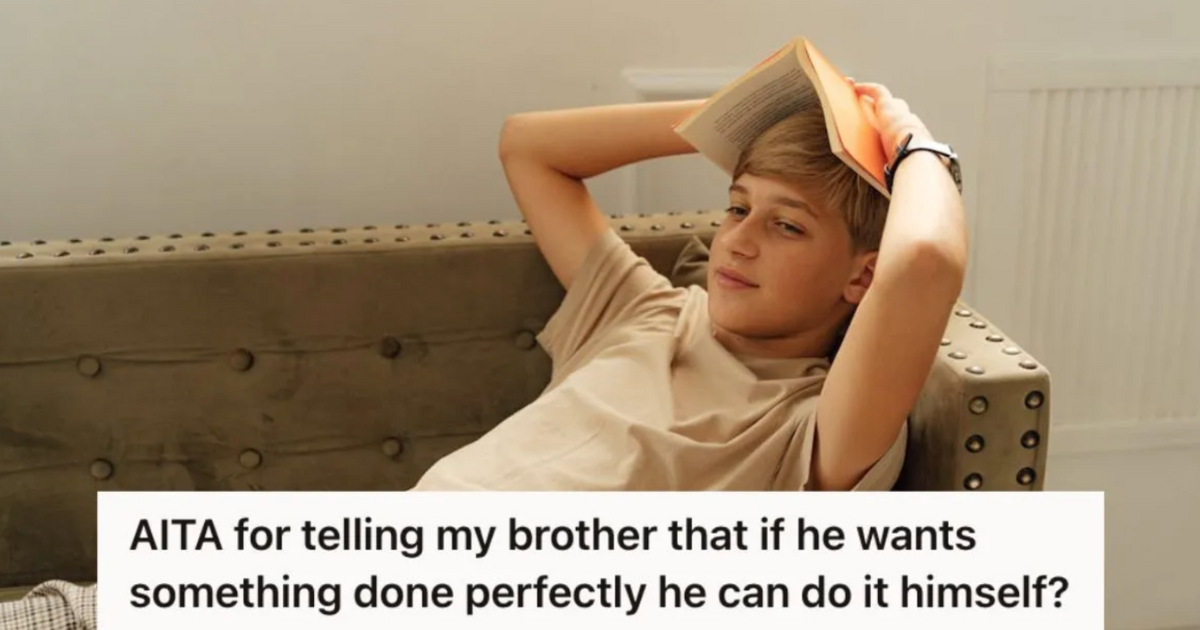 Teenage boy holding a book up on his head