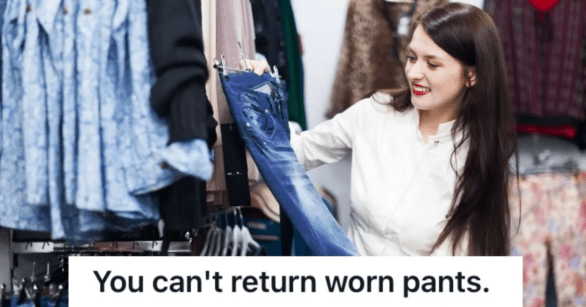 happy woman holding a pair of jeans