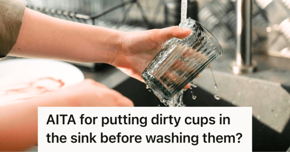 man washing a cup in the sink