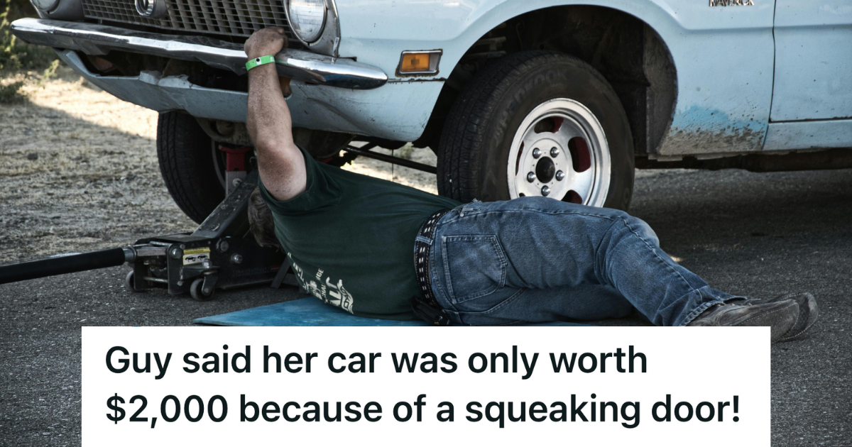 mechanic looking under hood of car