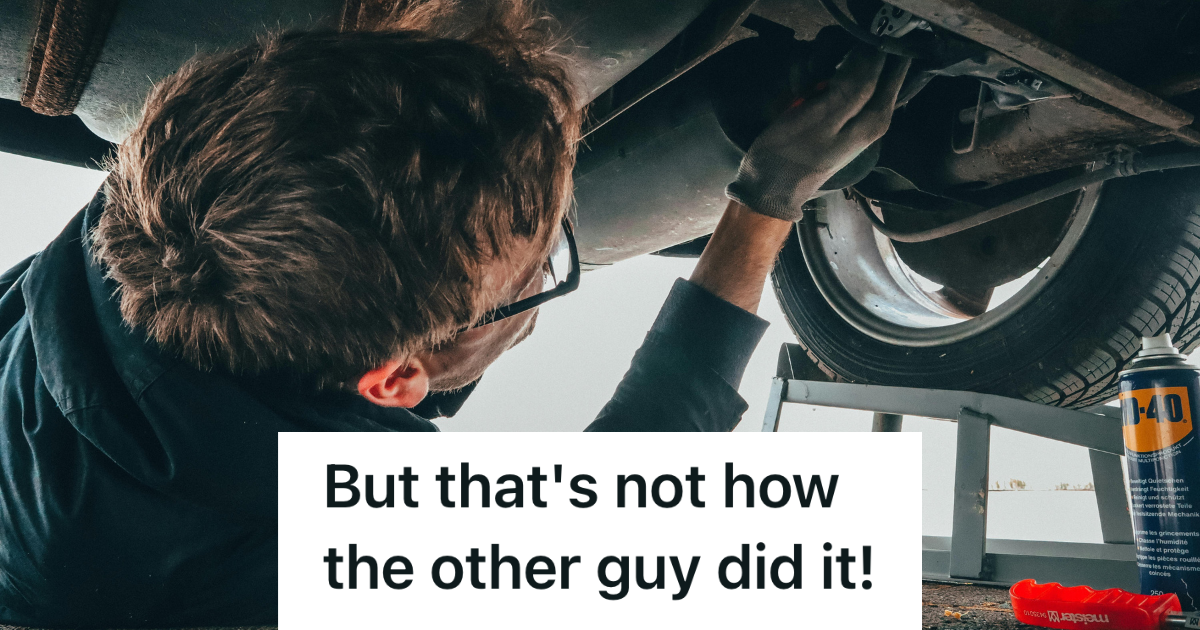 mechanic working on underside of car