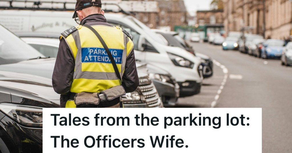 Parking attendant standing in front of a row of parked cars