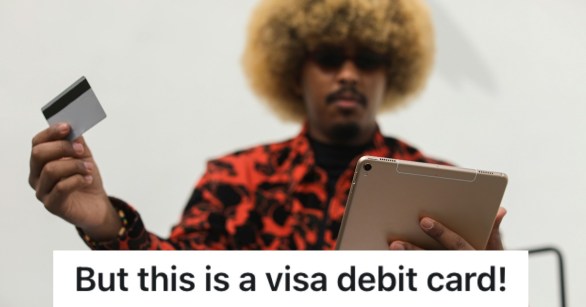 man holding a tablet and a credit card