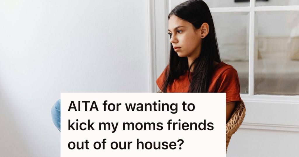 Girl in a red shirt with long brown hair looking sad while sitting in a chair.