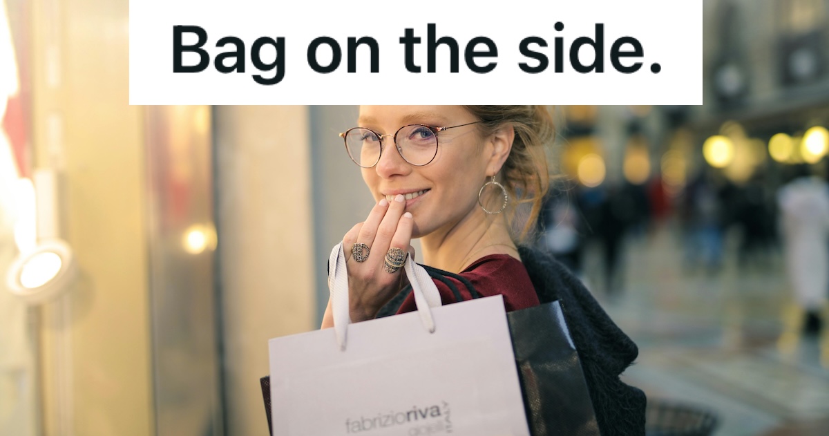 woman in glasses holding shopping bag