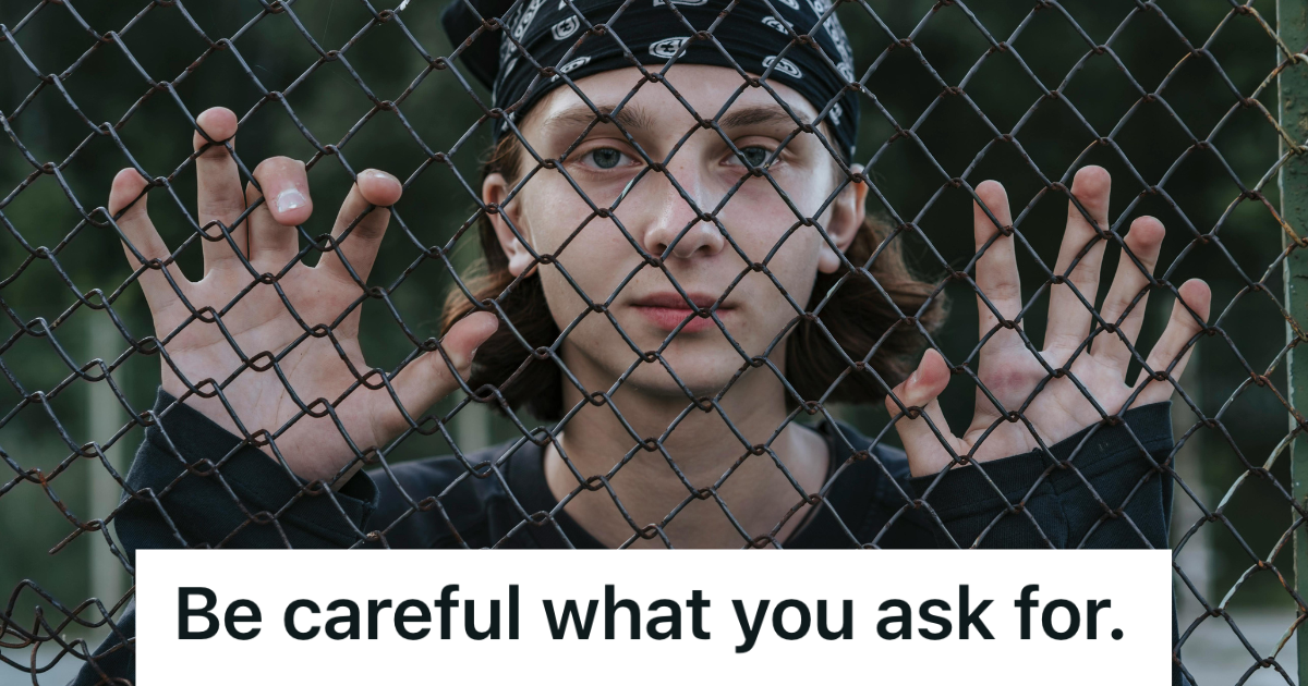teenager gripping a chain link fence