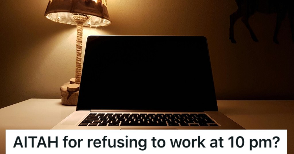 A laptop with a lamp behind it