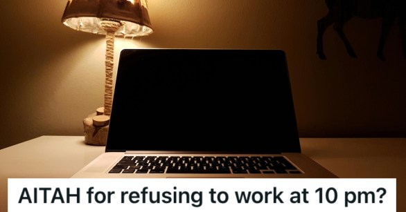 A laptop with a lamp behind it