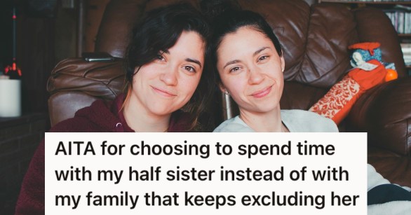 Two sisters smiling by a couch