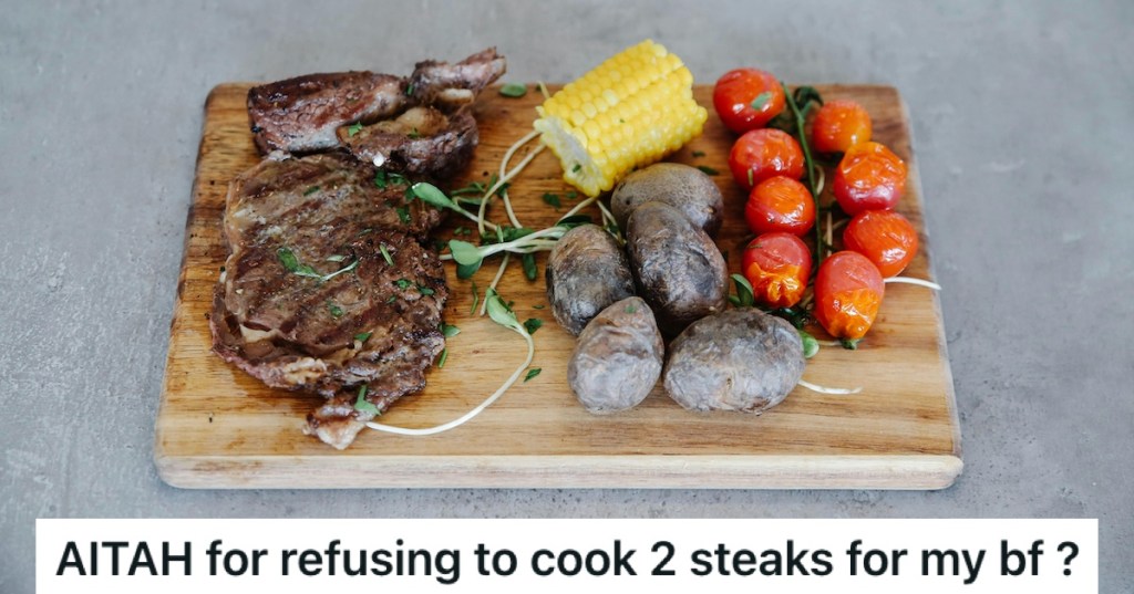 Steak on a board with tomatoes, mushrooms and corn cobs