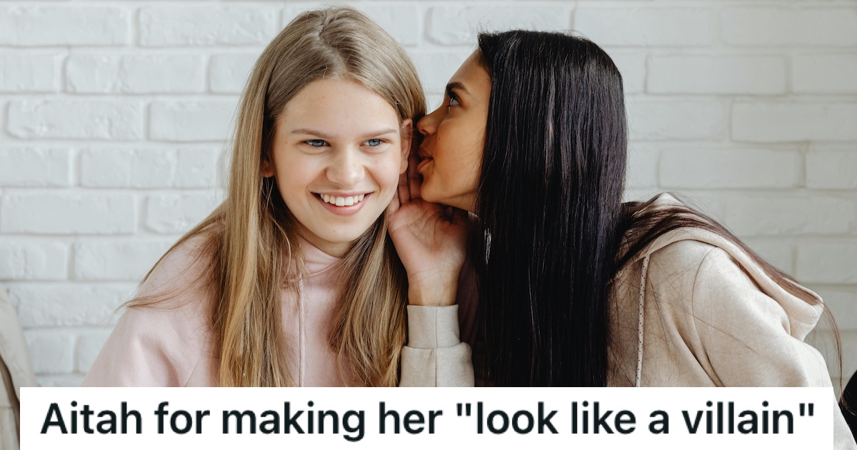 A girl whispering in her friend's ear