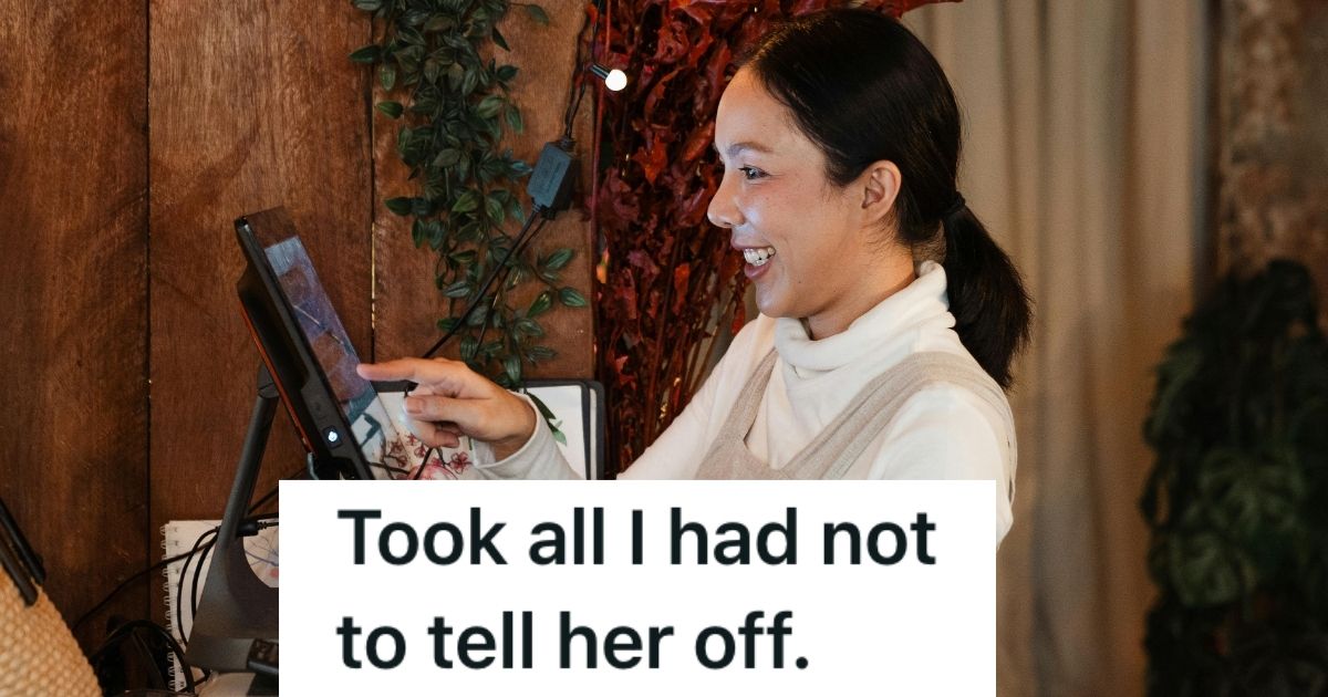 Female cashier smiling at the cash register