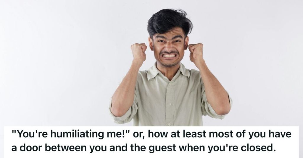 Angry man scowling with his fists facing the ceiling