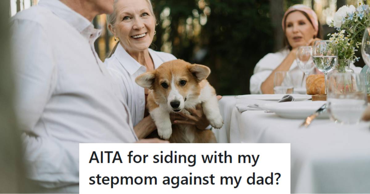 Woman handing her corgi to her husband at the table outside