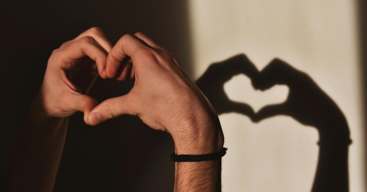 Hands and a shadow in a heart shape