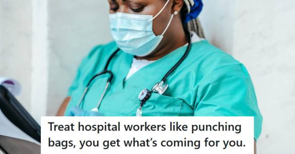 Nurse standing in the hospital wearing a mask and using a tablet.