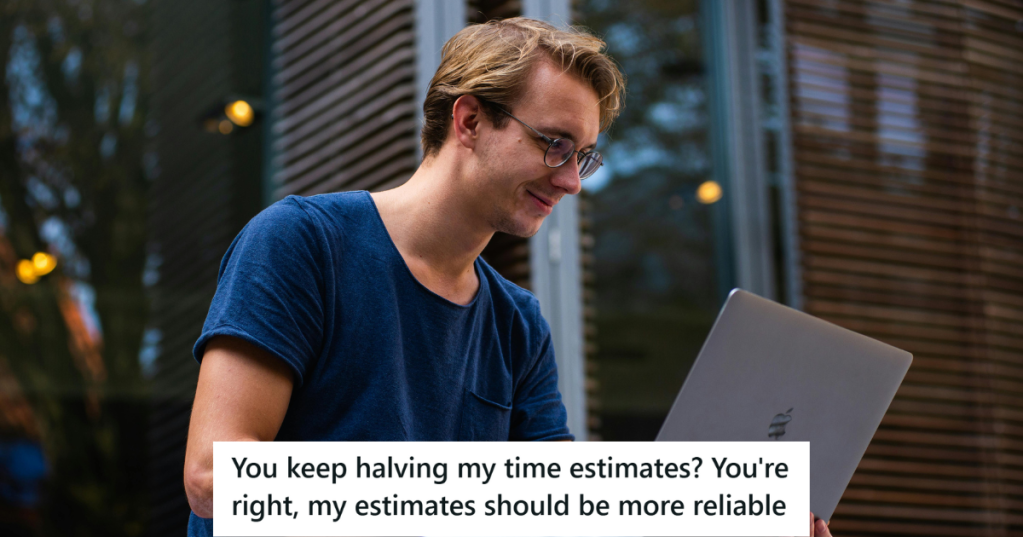 Man in blue t shirt working on his laptop